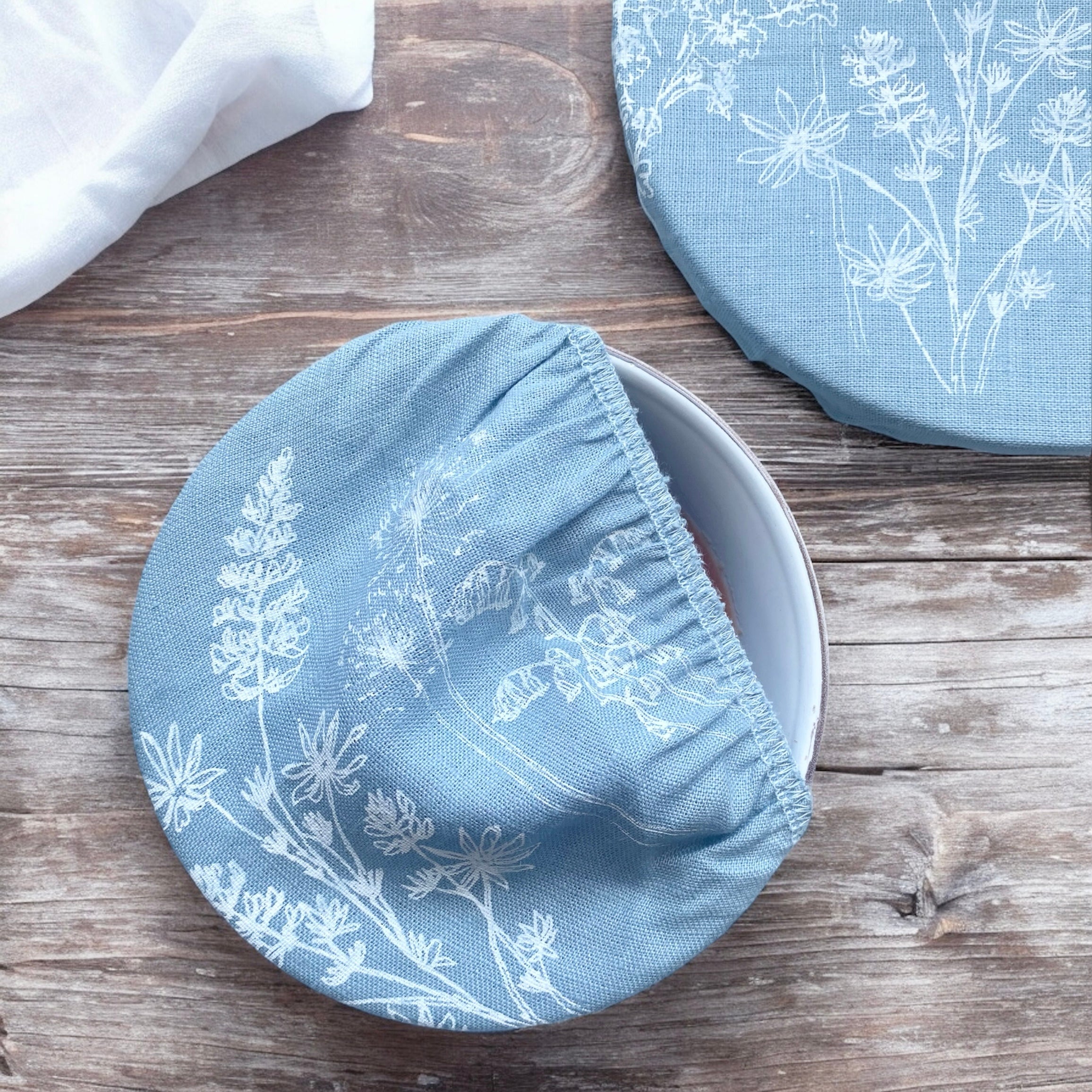 Eco-friendly linen bowl cover with blue floral pattern for sustainable food storage
